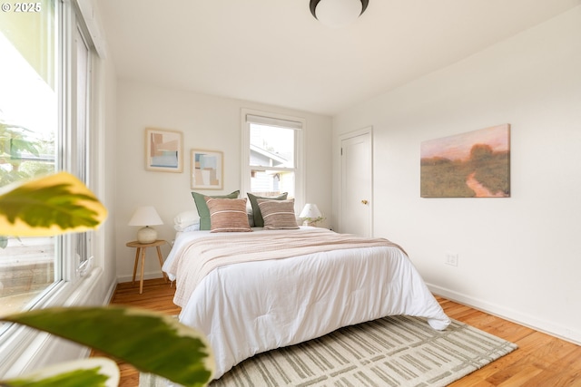 bedroom with wood finished floors and baseboards