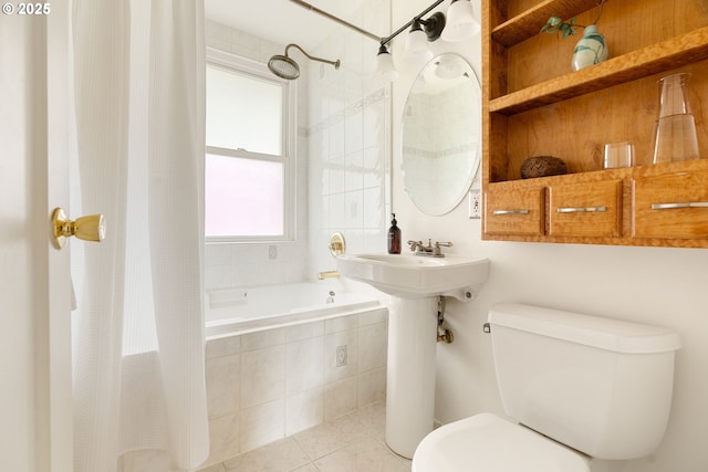 bathroom featuring tiled shower / bath combo, tile patterned flooring, and toilet