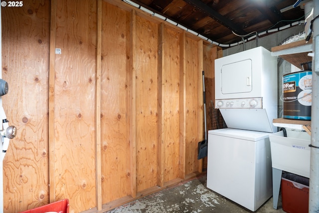 laundry area featuring stacked washer / dryer