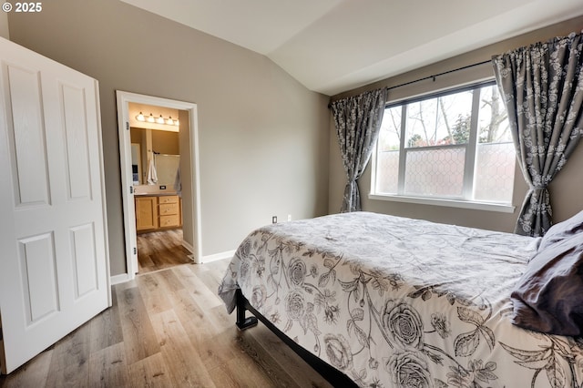 10955 SW 130th Ave, Tigard, OR 97223 - bedroom with vaulted ceiling, wood finished floors, and ensuite bathroom