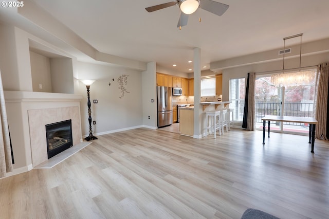 10955 SW 130th Ave, Tigard, OR 97223 - unfurnished living room with a ceiling fan, recessed lighting, light wood-type flooring, and a premium fireplace