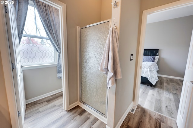 10955 SW 130th Ave, Tigard, OR 97223 - bathroom featuring wood finished floors, a stall shower, and connected bathroom