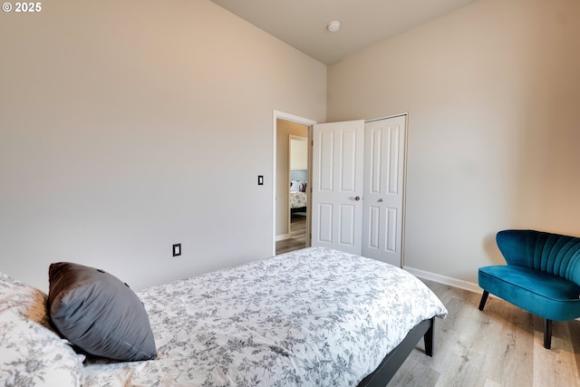 10955 SW 130th Ave, Tigard, OR 97223 - bedroom with wood finished floors, a towering ceiling, and a closet