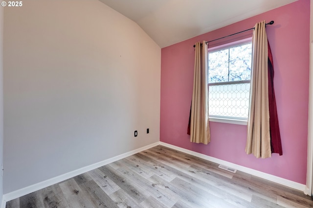 10955 SW 130th Ave, Tigard, OR 97223 - spare room with vaulted ceiling and light wood-style flooring