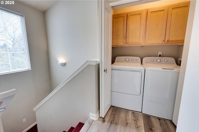 10955 SW 130th Ave, Tigard, OR 97223 - laundry room featuring cabinet space, independent washer and dryer, healthy amount of natural light, and light wood-style floors