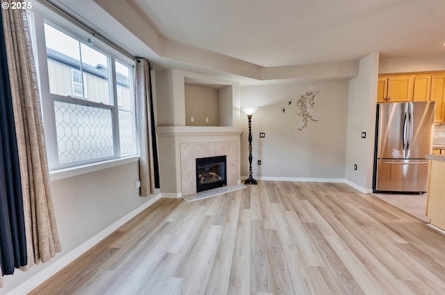 10955 SW 130th Ave, Tigard, OR 97223 - unfurnished living room with light wood-style flooring and a fireplace