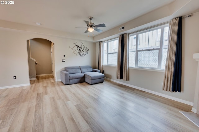 10955 SW 130th Ave, Tigard, OR 97223 - living area with arched walkways, a ceiling fan, and light wood-style floors