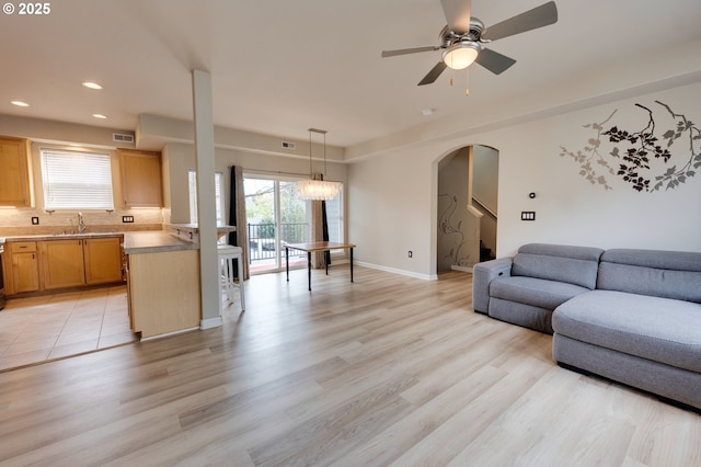 10955 SW 130th Ave, Tigard, OR 97223 - living room featuring arched walkways, recessed lighting, a ceiling fan, and light wood finished floors