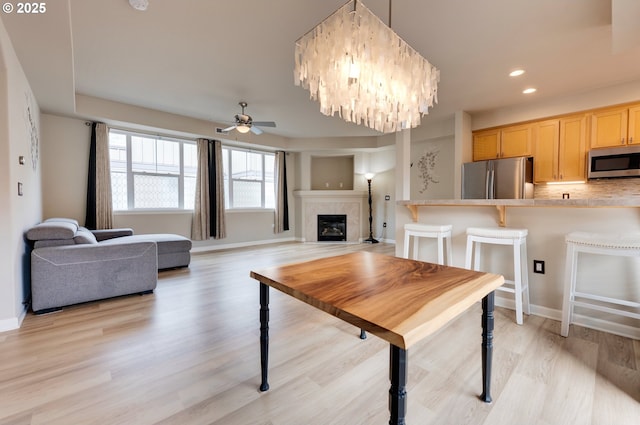 10955 SW 130th Ave, Tigard, OR 97223 - dining room with a fireplace with flush hearth, ceiling fan, light wood-type flooring, and recessed lighting