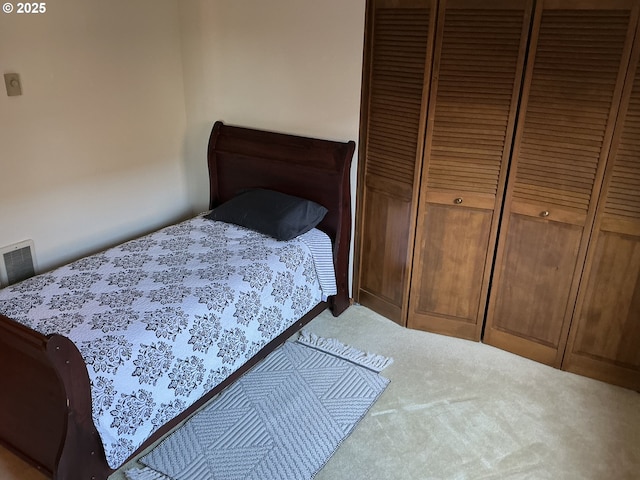 bedroom featuring a closet and light carpet