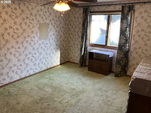 interior space featuring ceiling fan, light colored carpet, and electric panel