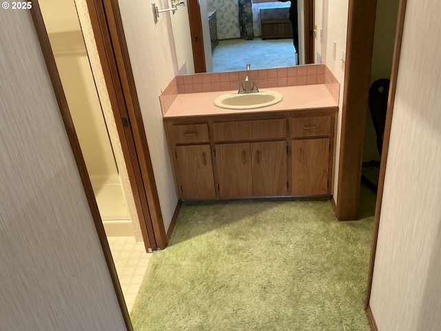 bathroom featuring vanity, decorative backsplash, and a shower