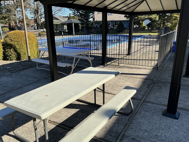 view of patio / terrace featuring a gazebo and a community pool