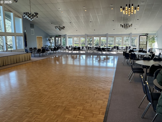 workout area featuring parquet floors, a wealth of natural light, and a high ceiling