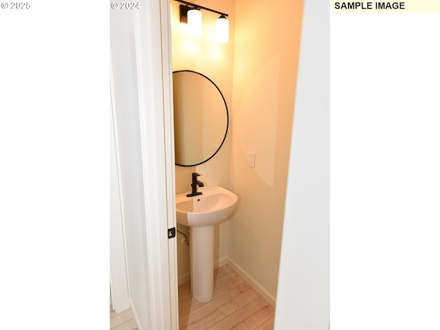bathroom featuring wood finished floors and baseboards