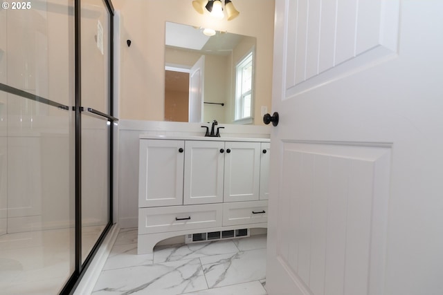 bathroom featuring visible vents, marble finish floor, vanity, and a shower stall