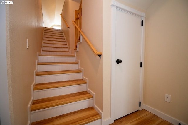 staircase featuring wood finished floors