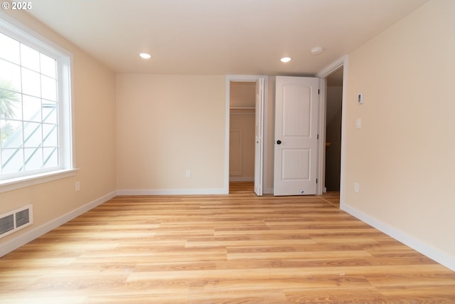 unfurnished room with recessed lighting, baseboards, visible vents, and light wood-style flooring