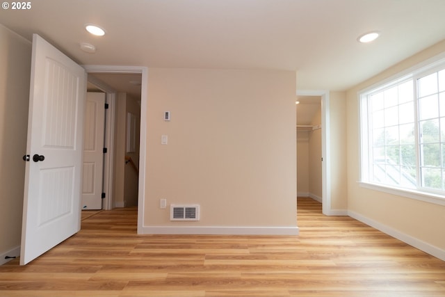 unfurnished bedroom featuring recessed lighting, baseboards, visible vents, and multiple windows