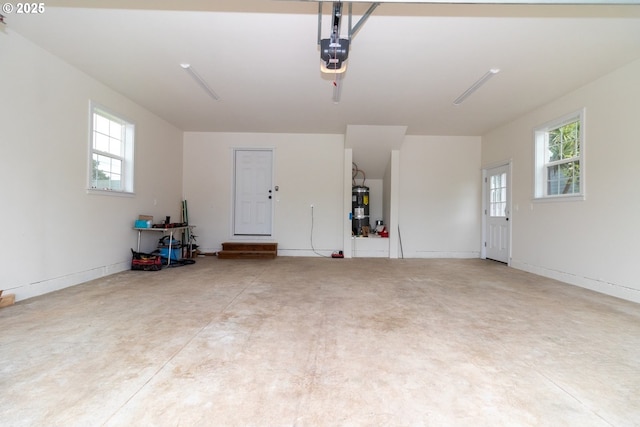 garage with a garage door opener and strapped water heater