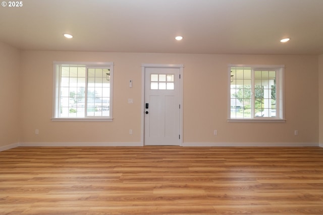 entrance foyer featuring baseboards, recessed lighting, and light wood-type flooring