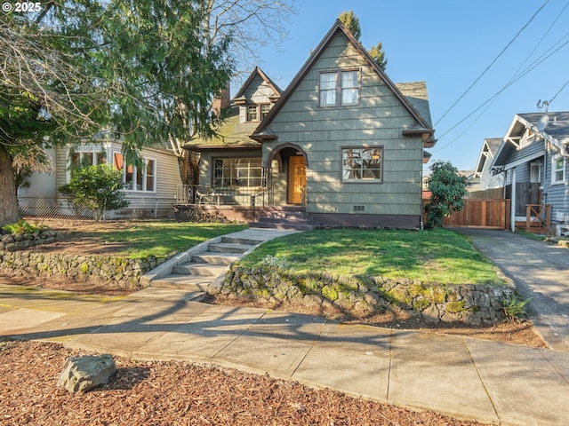 tudor home with a front yard