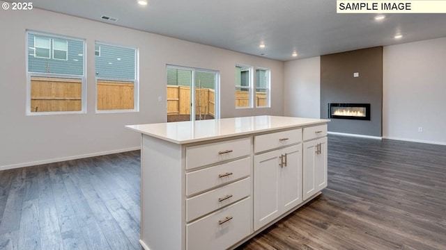 2131 NE 3rd Ave, Battle Ground, WA 98604 - kitchen featuring dark wood-style flooring, a center island, white cabinets, a fireplace, and recessed lighting