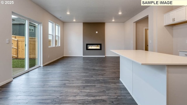 2131 NE 3rd Ave, Battle Ground, WA 98604 - unfurnished living room featuring recessed lighting, dark wood-style flooring, a large fireplace, and baseboards