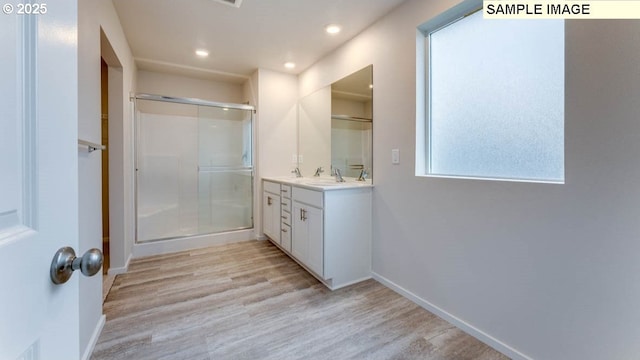 2131 NE 3rd Ave, Battle Ground, WA 98604 - bathroom featuring a stall shower, vanity, wood finished floors, baseboards, and recessed lighting