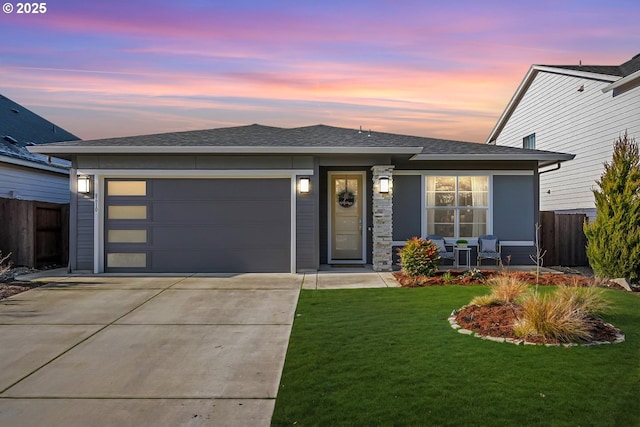 view of front facade with a garage and a lawn