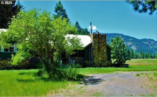 62242 Tamarack Springs Ln, Summerville, OR 97876 - view of front of property with a chimney and a mountain view