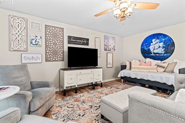 living room featuring wood-type flooring and ceiling fan