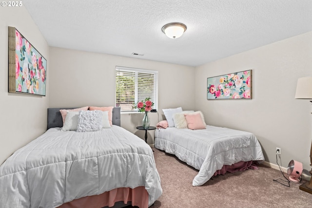 bedroom featuring carpet floors and a textured ceiling