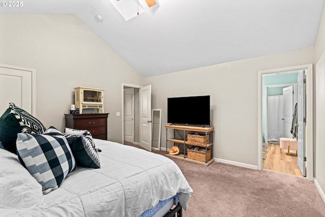 carpeted bedroom featuring high vaulted ceiling, ceiling fan, and ensuite bathroom