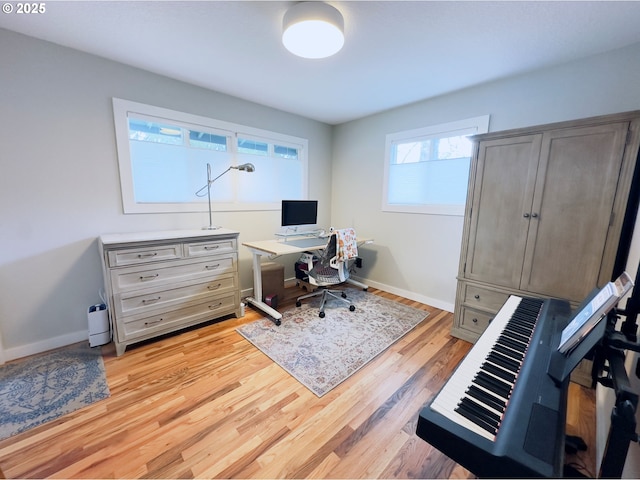 office area with light wood-type flooring and baseboards