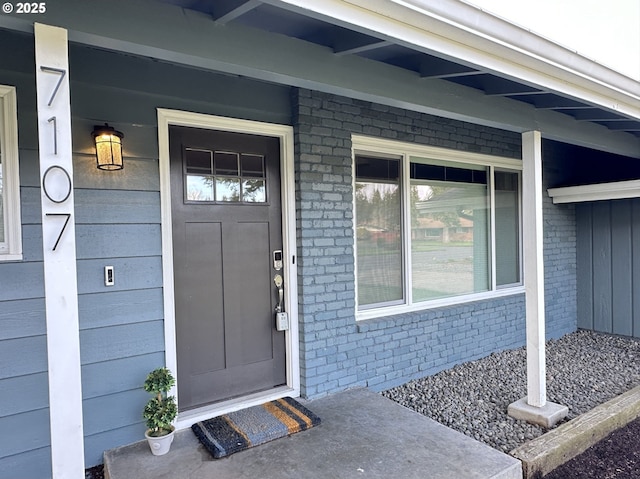 entrance to property featuring brick siding