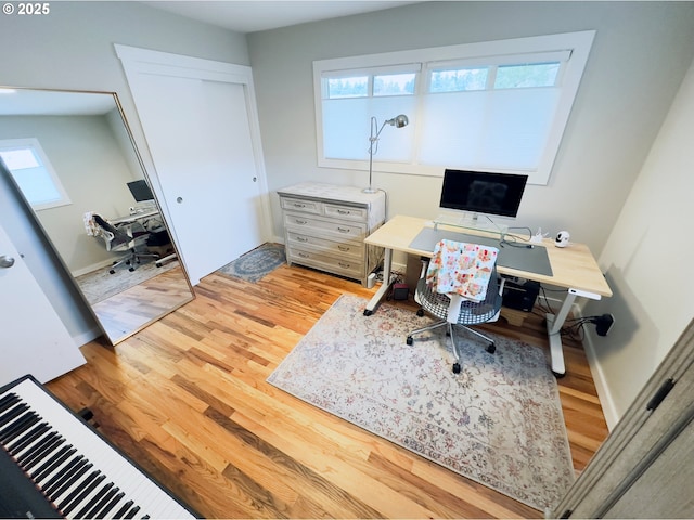 home office featuring light wood finished floors and baseboards