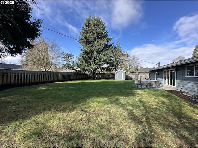 view of yard featuring a storage shed, a fenced backyard, and an outdoor structure