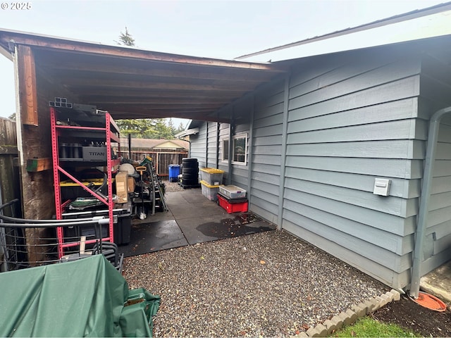 view of car parking featuring a carport and fence