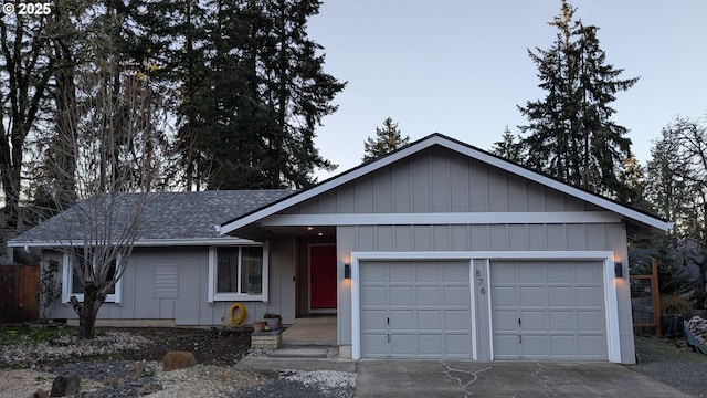 ranch-style house with a garage, concrete driveway, and roof with shingles