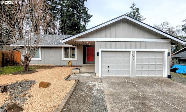 ranch-style house with an attached garage, a shingled roof, driveway, and fence