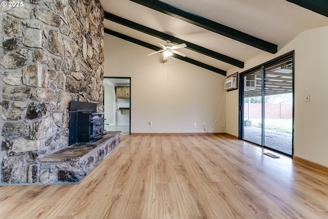 unfurnished living room with hardwood / wood-style floors, a wall mounted AC, vaulted ceiling with beams, ceiling fan, and a wood stove