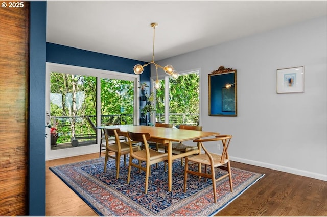 2975 SW Canterbury Ln, Portland, OR 97205 - dining area with baseboards, wood finished floors, and a chandelier