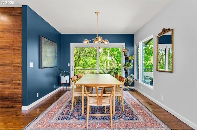 2975 SW Canterbury Ln, Portland, OR 97205 - dining area featuring baseboards, a chandelier, and wood finished floors
