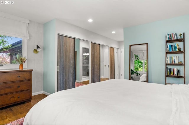 2975 SW Canterbury Ln, Portland, OR 97205 - bedroom featuring dark wood finished floors, multiple closets, recessed lighting, and baseboards