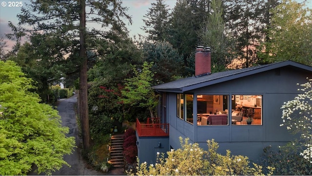 2975 SW Canterbury Ln, Portland, OR 97205 - view of side of home with stairway and a chimney
