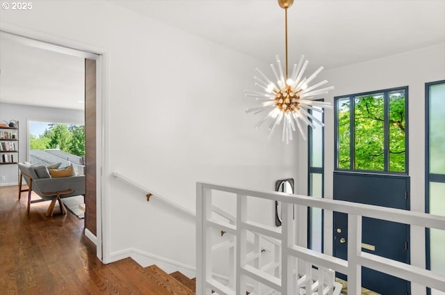 2975 SW Canterbury Ln, Portland, OR 97205 - hall featuring a chandelier, dark wood-style flooring, and baseboards