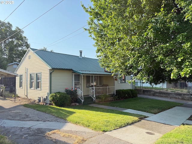 104 NW 12th St, Pendleton, OR 97801 - view of front of house featuring a porch, a front lawn, and metal roof