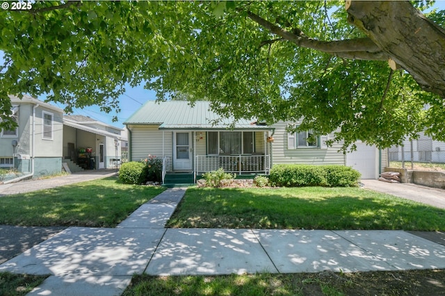104 NW 12th St, Pendleton, OR 97801 - view of front facade with covered porch, a front lawn, a metal roof, and a garage