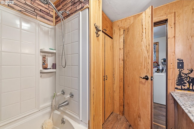 bathroom featuring tub / shower combination and wood finished floors